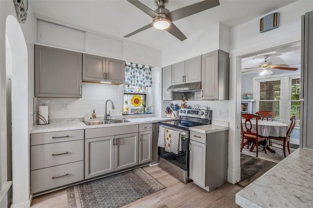 432 Kenmont Ave, Mt Lebanon, PA 15228 - kitchen featuring stainless steel electric range, gray cabinetry, ceiling fan, under cabinet range hood, and light wood-type flooring