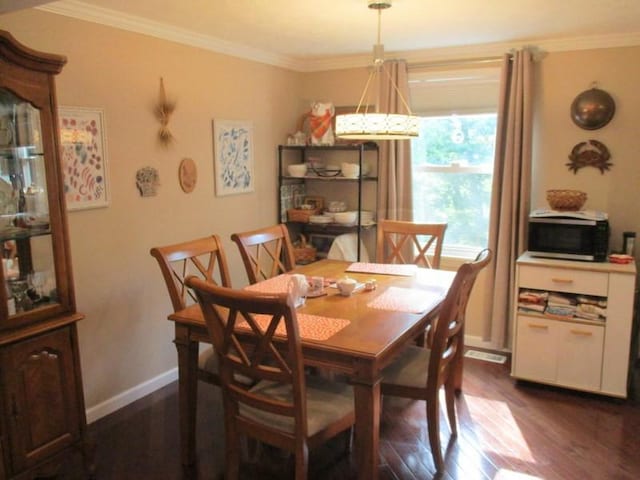 5025 Bocktown Rd, Hopewell Twp, PA 15001 - dining room featuring dark wood-type flooring and crown molding