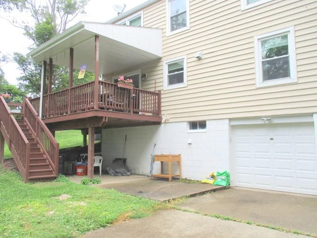 5025 Bocktown Rd, Hopewell Twp, PA 15001 - rear view of property featuring an attached garage, stairway, a deck, and driveway