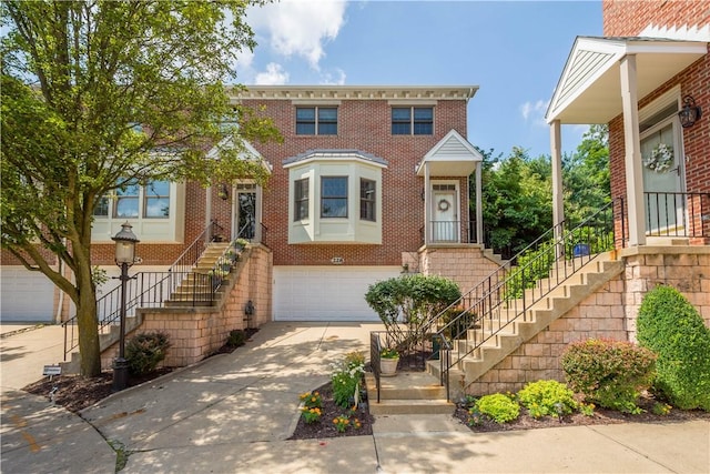 228 Highpointe Dr, Pittsburgh, PA 15220 - view of front of home featuring stairway, concrete driveway, a garage, and brick siding