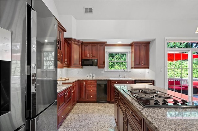 228 Highpointe Dr, Pittsburgh, PA 15220 - kitchen with black appliances, light stone countertops, and tasteful backsplash