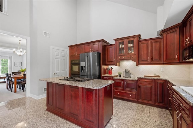 228 Highpointe Dr, Pittsburgh, PA 15220 - kitchen featuring black appliances, dark brown cabinets, granite tiled floors, a chandelier, and a towering ceiling