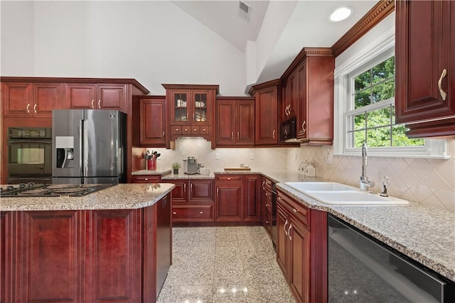 228 Highpointe Dr, Pittsburgh, PA 15220 - kitchen featuring black appliances, dark brown cabinets, vaulted ceiling, and backsplash