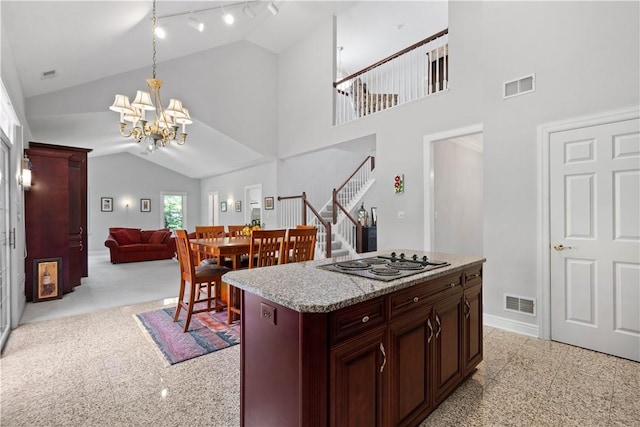 228 Highpointe Dr, Pittsburgh, PA 15220 - kitchen with cooktop, a chandelier, light countertops, decorative light fixtures, and reddish brown cabinets