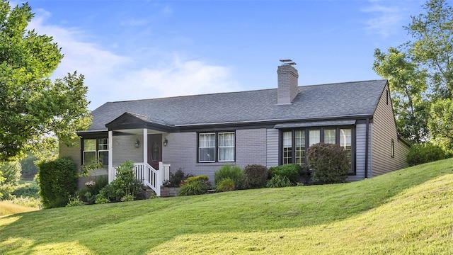 341 E Mcmurray, Peters Twp, PA 15317 - view of front of house with a front yard, a chimney, brick siding, and roof with shingles