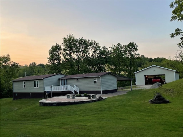 170 Laidleys Run Rd, West Finley, PA 15376 - back of house featuring a detached garage, a deck, a lawn, and an outbuilding