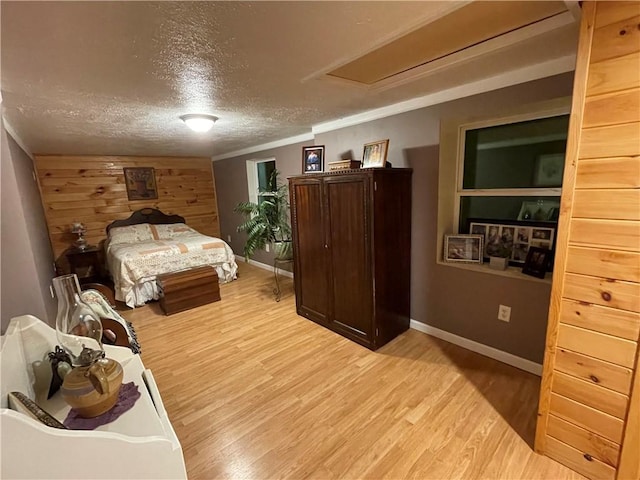 170 Laidleys Run Rd, West Finley, PA 15376 - bedroom featuring light wood finished floors, wood walls, and a textured ceiling