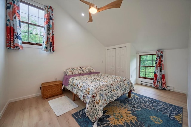 214 Youngs Ln, Sugarcreek, PA 16323 - bedroom featuring wood finished floors, a closet, vaulted ceiling, a baseboard heating unit, and ceiling fan