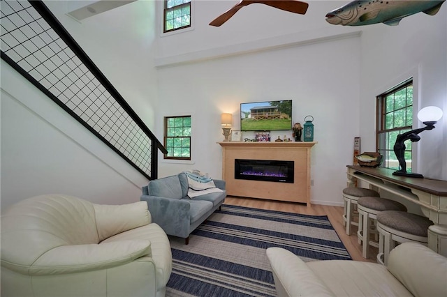 214 Youngs Ln, Sugarcreek, PA 16323 - living room with plenty of natural light, a high ceiling, wood finished floors, ceiling fan, and stairs
