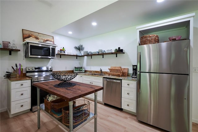 214 Youngs Ln, Sugarcreek, PA 16323 - kitchen featuring appliances with stainless steel finishes, open shelves, white cabinetry, light wood finished floors, and recessed lighting