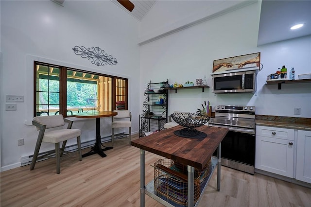 214 Youngs Ln, Sugarcreek, PA 16323 - kitchen with appliances with stainless steel finishes, open shelves, a baseboard heating unit, light wood-style floors, and high vaulted ceiling