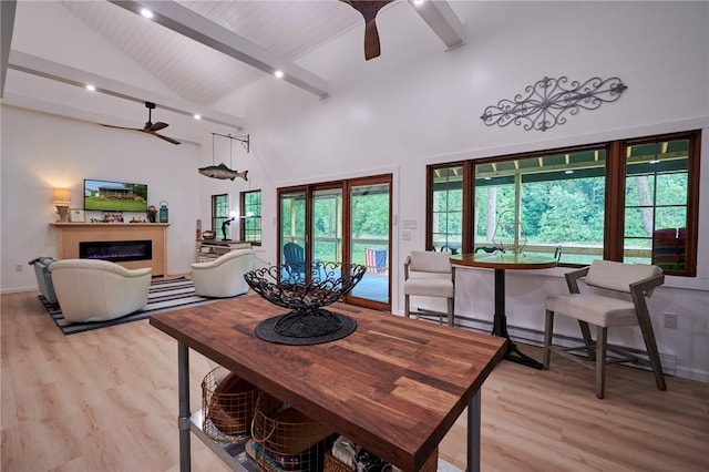 214 Youngs Ln, Sugarcreek, PA 16323 - dining space with ceiling fan, light wood finished floors, a fireplace, high vaulted ceiling, and beam ceiling