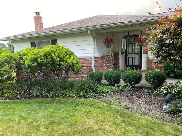 39 Hogue Rd, West Middlesex Boro, PA 16159 - view of front of home with brick siding, roof with shingles, a front yard, and a chimney