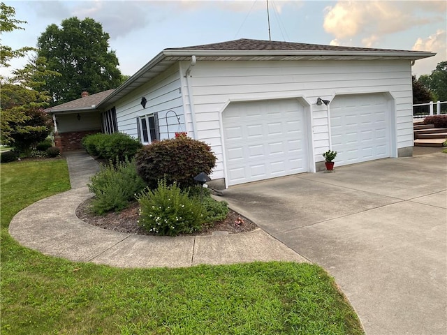 39 Hogue Rd, West Middlesex Boro, PA 16159 - view of side of property with concrete driveway, a lawn, and a shingled roof