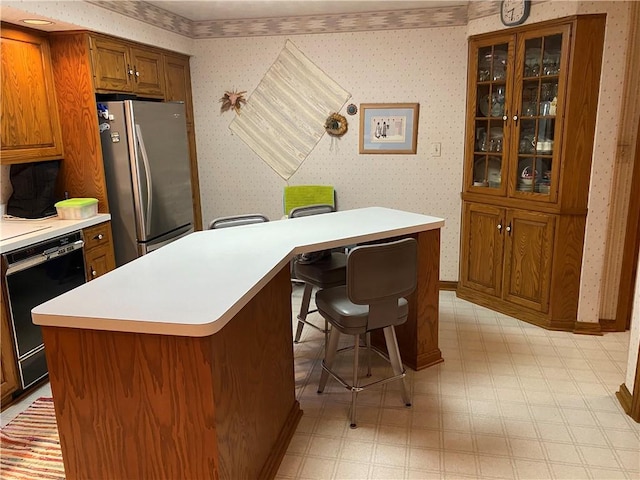 39 Hogue Rd, West Middlesex Boro, PA 16159 - kitchen featuring wallpapered walls, brown cabinetry, freestanding refrigerator, dishwasher, and light floors