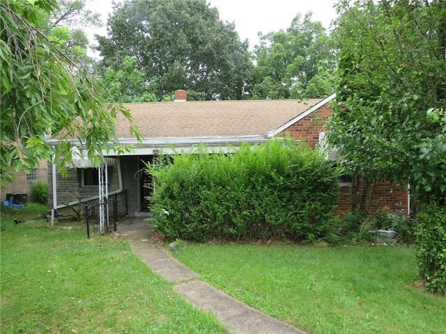 150 Marshall Dr, Penn Hills, PA 15235 - bungalow-style house with a front lawn, brick siding, roof with shingles, and a chimney