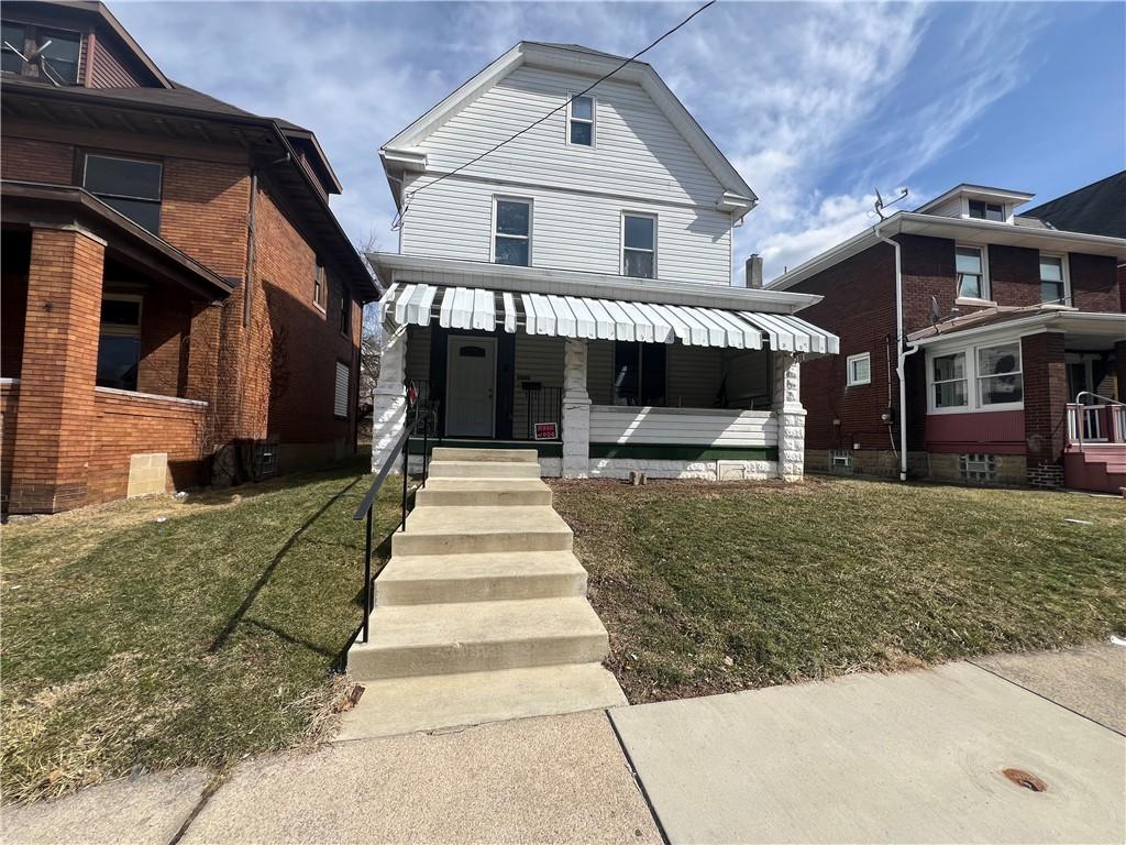 1320 Leishman Ave, New Kensington, PA 15068 - american foursquare style home with a front yard and a porch