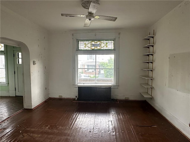 1532 Orangewood Ave, Beechview, PA 15216 - empty room featuring radiator heating unit, hardwood / wood-style floors, arched walkways, and ceiling fan