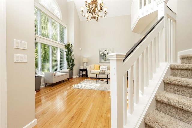 652 Cheyenne Trl, Jackson Twp, PA 16137 - stairway featuring wood finished floors and a chandelier