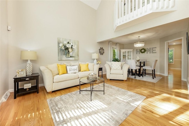 652 Cheyenne Trl, Jackson Twp, PA 16137 - living room featuring wood finished floors and a towering ceiling