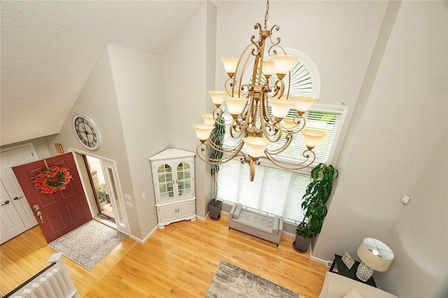 652 Cheyenne Trl, Jackson Twp, PA 16137 - entrance foyer featuring a chandelier, high vaulted ceiling, and wood finished floors