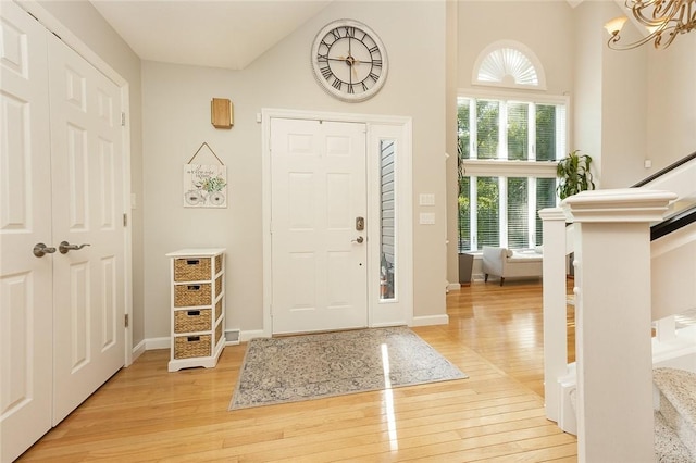 652 Cheyenne Trl, Jackson Twp, PA 16137 - foyer with light wood-style flooring, a chandelier, and a towering ceiling