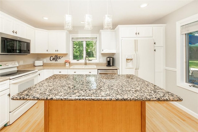 652 Cheyenne Trl, Jackson Twp, PA 16137 - kitchen featuring stainless steel appliances, a kitchen island, light wood-style floors, light stone counters, and recessed lighting