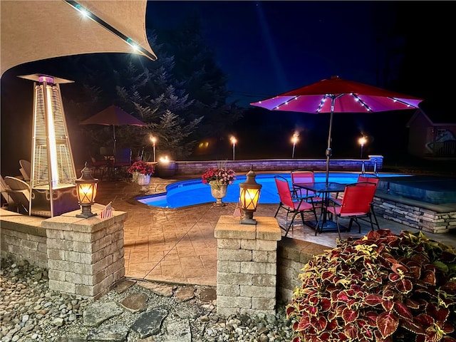 652 Cheyenne Trl, Jackson Twp, PA 16137 - pool at night featuring a patio and outdoor dining space