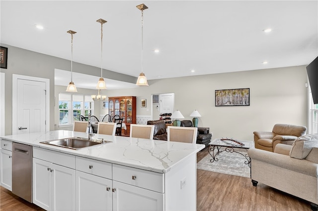 106 High Pointe Dr, Chartiers, PA 15301 - kitchen with stainless steel dishwasher, open floor plan, light wood finished floors, white cabinets, and a chandelier