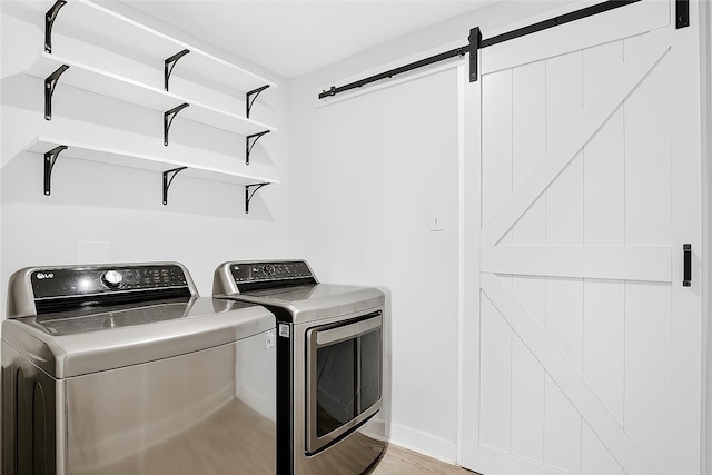 106 High Pointe Dr, Chartiers, PA 15301 - washroom with separate washer and dryer, a barn door, and light wood-style flooring