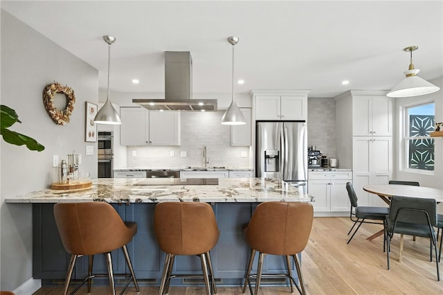 1206 Carla Dr, Blawnox, PA 15238 - kitchen with island exhaust hood, appliances with stainless steel finishes, white cabinetry, tasteful backsplash, and recessed lighting
