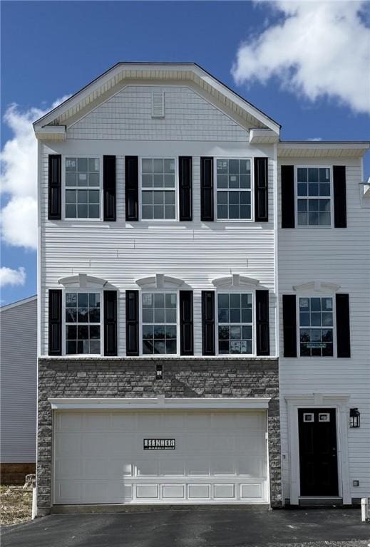 173 Lockheed Dr, Moon/Crescent Twp, PA 15108 - view of front of home featuring stone siding, an attached garage, and driveway