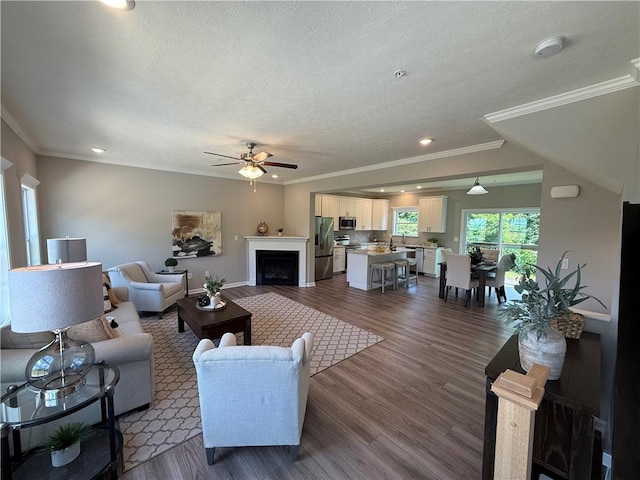 173 Lockheed Dr, Moon/Crescent Twp, PA 15108 - living room with ceiling fan, dark wood-style flooring, a textured ceiling, a fireplace, and ornamental molding