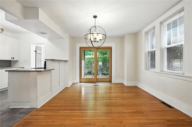 5248 Beelermont Pl, Squirrel Hill, PA 15217 - unfurnished dining area featuring a chandelier and hardwood / wood-style flooring
