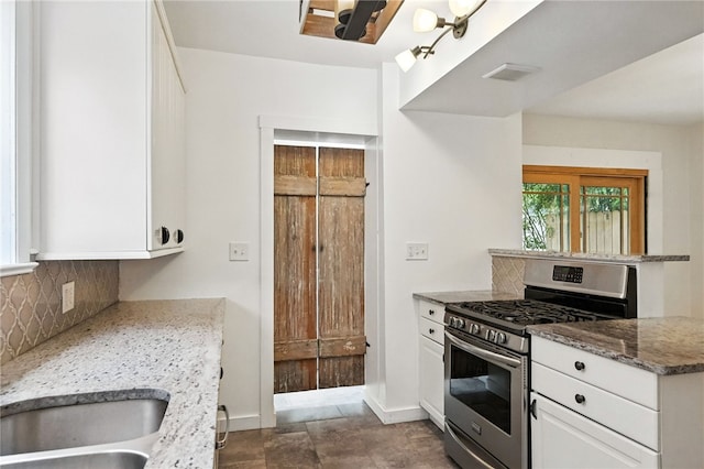 5248 Beelermont Pl, Squirrel Hill, PA 15217 - kitchen featuring stainless steel gas stove, decorative backsplash, white cabinetry, and light stone counters