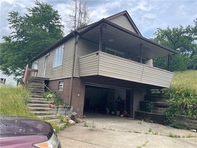 262 Twin Bridges Rd, Charleroi Boro, PA 15022 - view of side of home featuring an attached garage, driveway, stairway, and a balcony