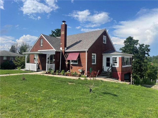 33 Orchard Ln, Carroll Twp, PA 15063 - bungalow-style home with brick siding, a chimney, a front lawn, and entry steps