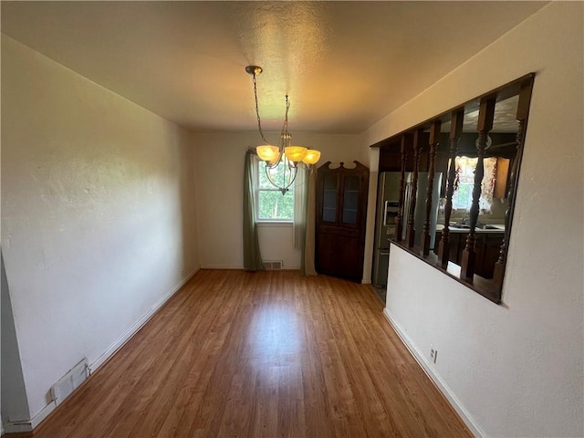 33 Orchard Ln, Carroll Twp, PA 15063 - unfurnished dining area with a chandelier and wood finished floors