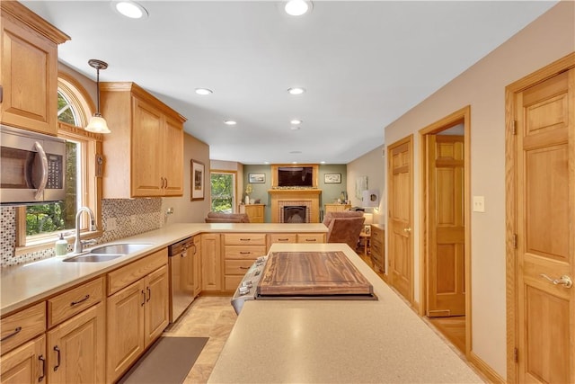115 Barrett Dr, Brighton Twp, PA 15009 - kitchen featuring stainless steel appliances, light countertops, recessed lighting, a fireplace, and backsplash