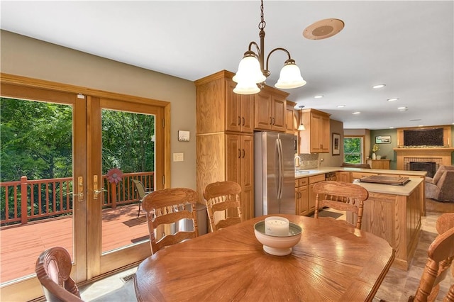 115 Barrett Dr, Brighton Twp, PA 15009 - dining area featuring french doors, recessed lighting, a brick fireplace, and a chandelier