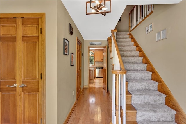 115 Barrett Dr, Brighton Twp, PA 15009 - stairway with wood-type flooring and a chandelier