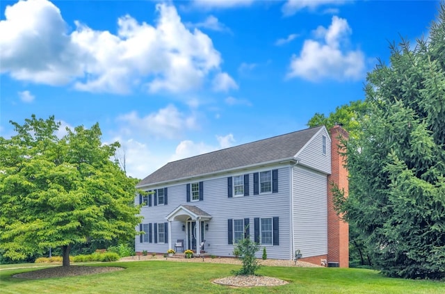 115 Barrett Dr, Brighton Twp, PA 15009 - colonial inspired home featuring a chimney and a front yard