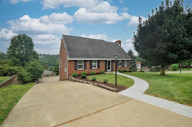 79 W Manilla Ave, Green Tree, PA 15220 - cape cod-style house with brick siding, concrete driveway, a front yard, and roof with shingles