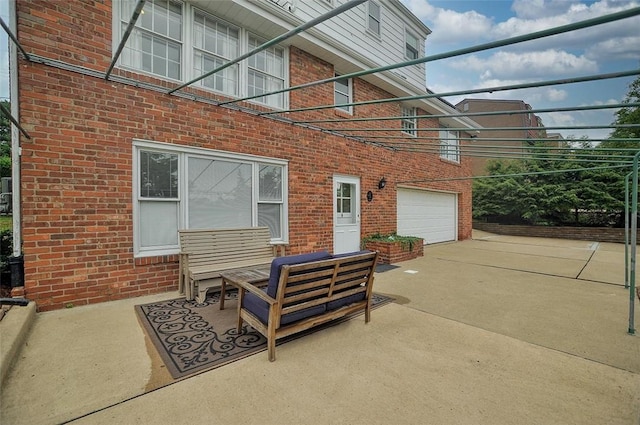 79 W Manilla Ave, Green Tree, PA 15220 - view of patio featuring a garage, concrete driveway, and an outdoor hangout area