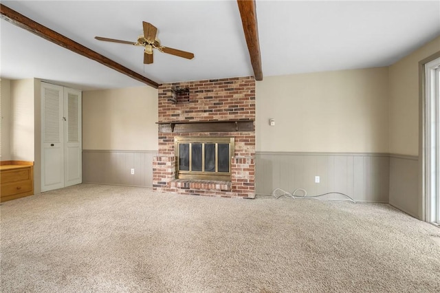 1308 Heather Heights Dr, Mccandless, PA 15101 - unfurnished living room featuring beamed ceiling, a ceiling fan, carpet flooring, wainscoting, and a fireplace