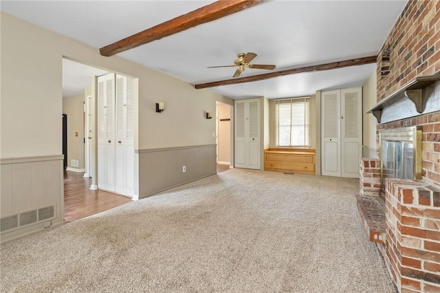 1308 Heather Heights Dr, Mccandless, PA 15101 - unfurnished living room with a fireplace, carpet floors, beam ceiling, ceiling fan, and wainscoting