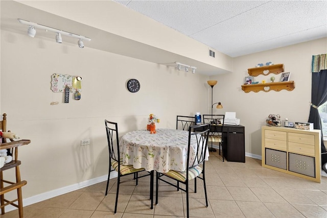 2120 Greentree Rd Unit 610E, Pittsburgh, PA 15220 - dining space featuring light tile patterned floors, a textured ceiling, and rail lighting