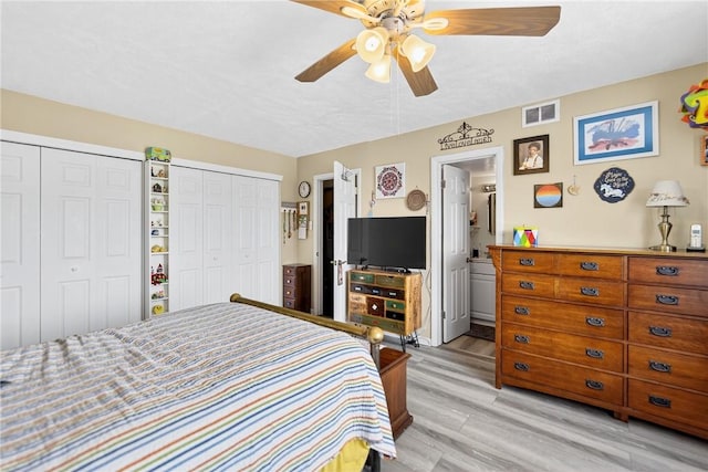 2120 Greentree Rd Unit 610E, Pittsburgh, PA 15220 - bedroom featuring two closets, light wood-type flooring, ceiling fan, and ensuite bath