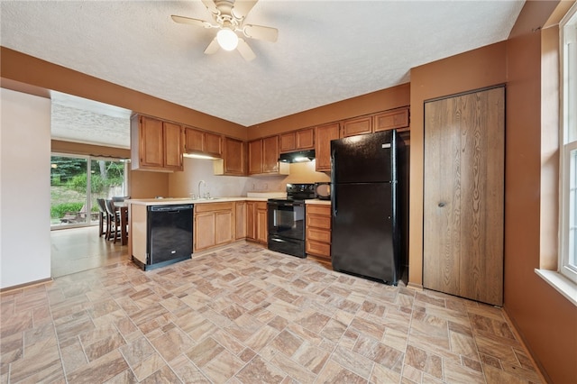 437 Shady Ridge Dr, Monroeville, PA 15146 - kitchen featuring black appliances, under cabinet range hood, light countertops, a ceiling fan, and light stone finish flooring