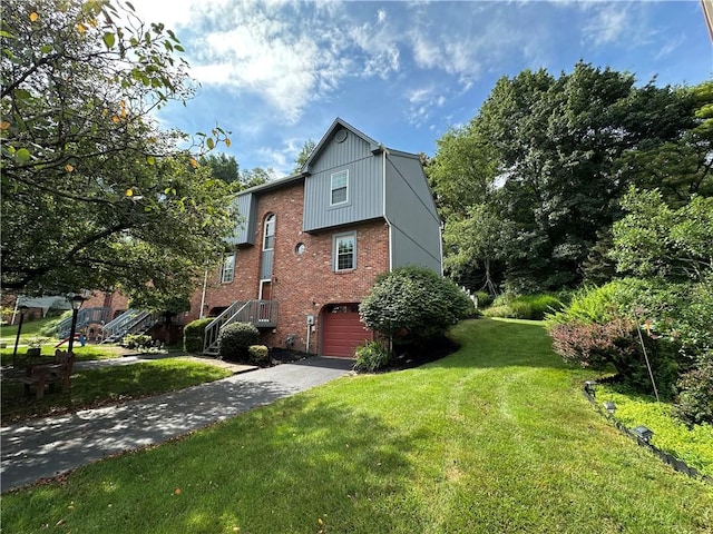 437 Shady Ridge Dr, Monroeville, PA 15146 - view of side of home featuring a garage, driveway, brick siding, and a lawn
